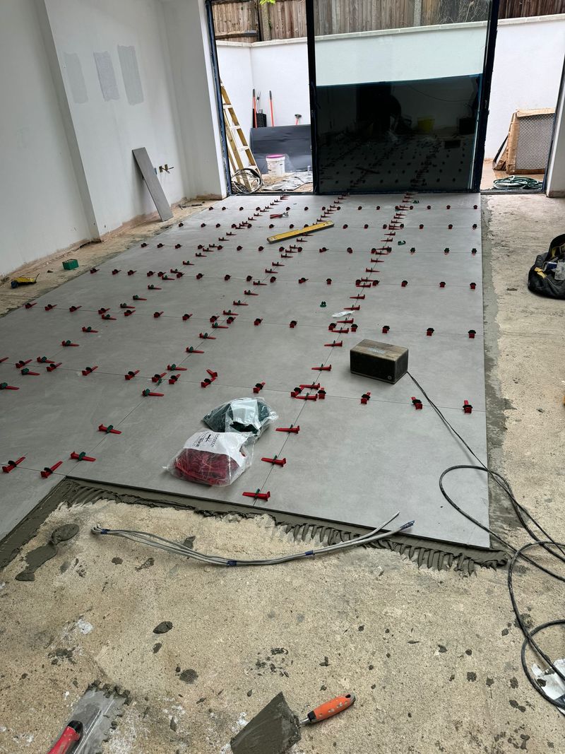 Large-format floor tiles being installed